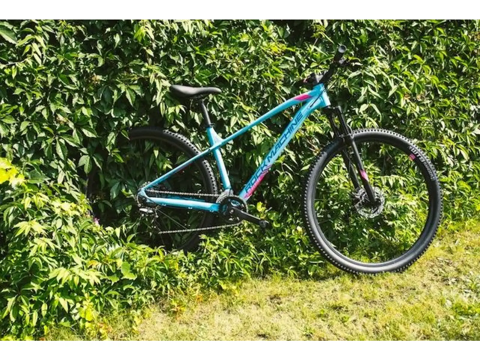Rock Machine Catherine 10-29 in Neon Cyan/Petrol/Pink mountain bike.